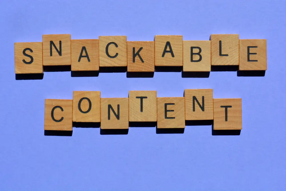 The words "snackable content" are listed using wooden letters.