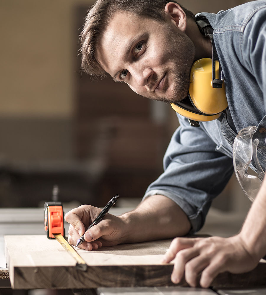 a person wearing ear muffs and measuring tape