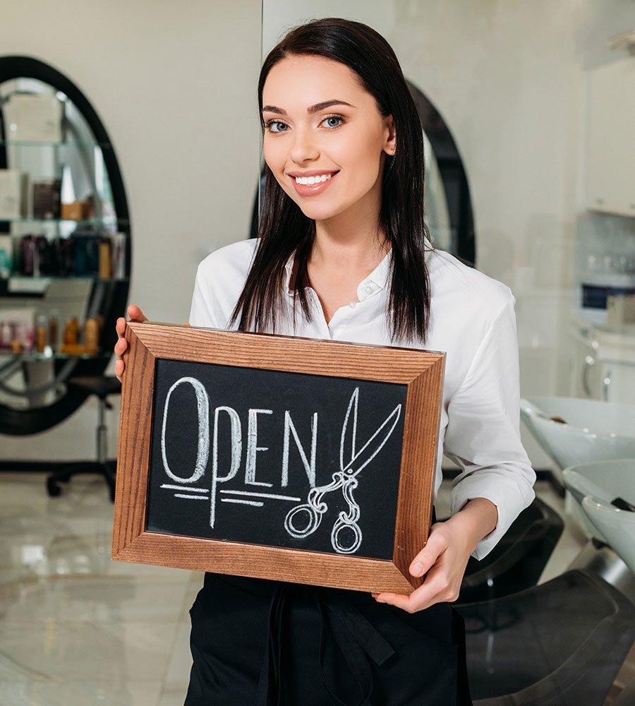 Business owner holding a sign