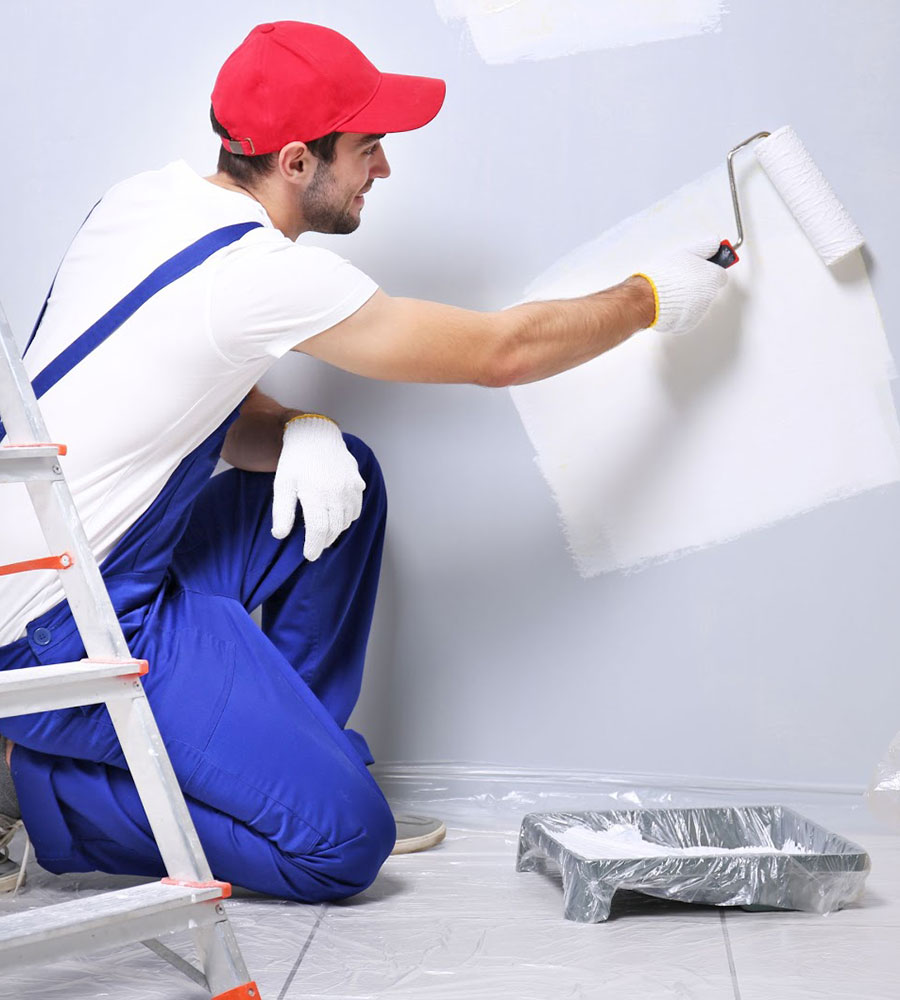 Man painting wall with roller.
