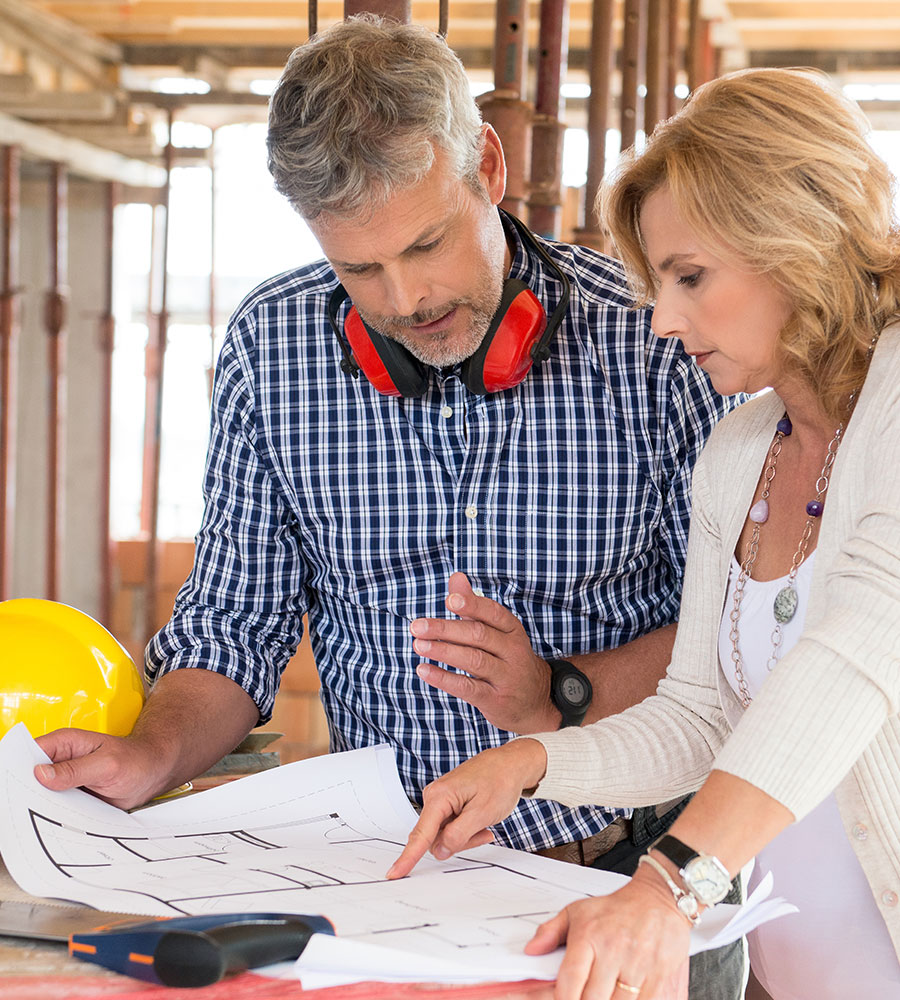 a person and person looking at a blueprint