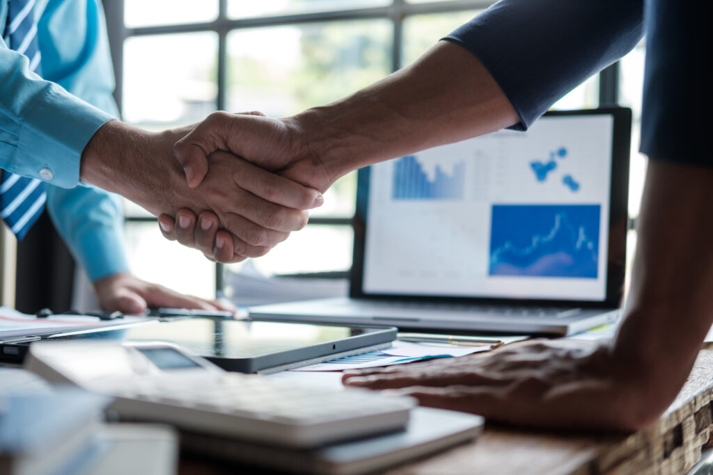 business handshake agreement success scaled