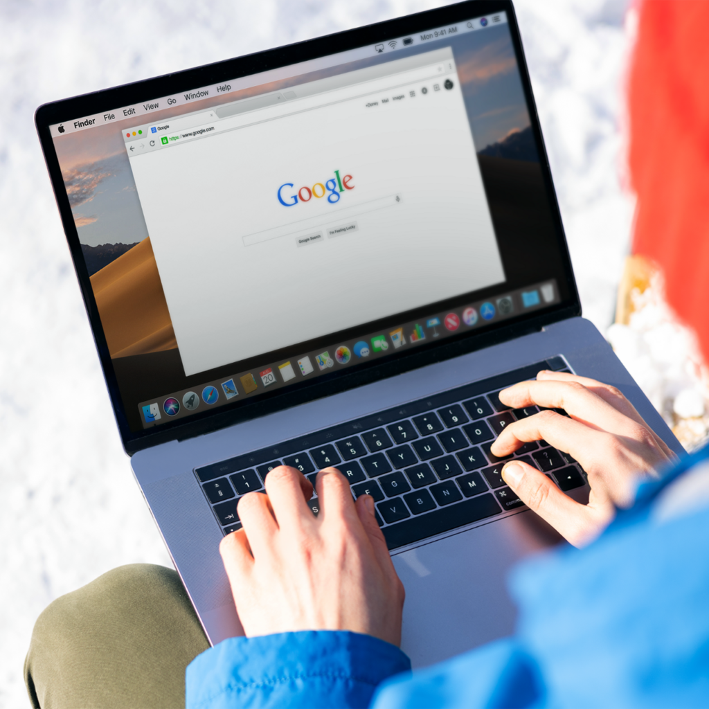 A person using google on laptop.