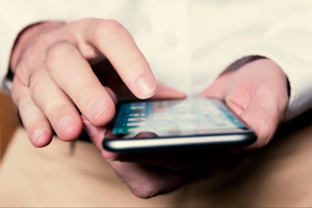 Person using a phone with applications on the screen