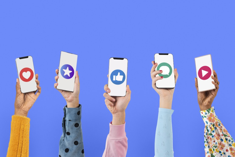 Multiple phone screens with social media icons are being held up.
